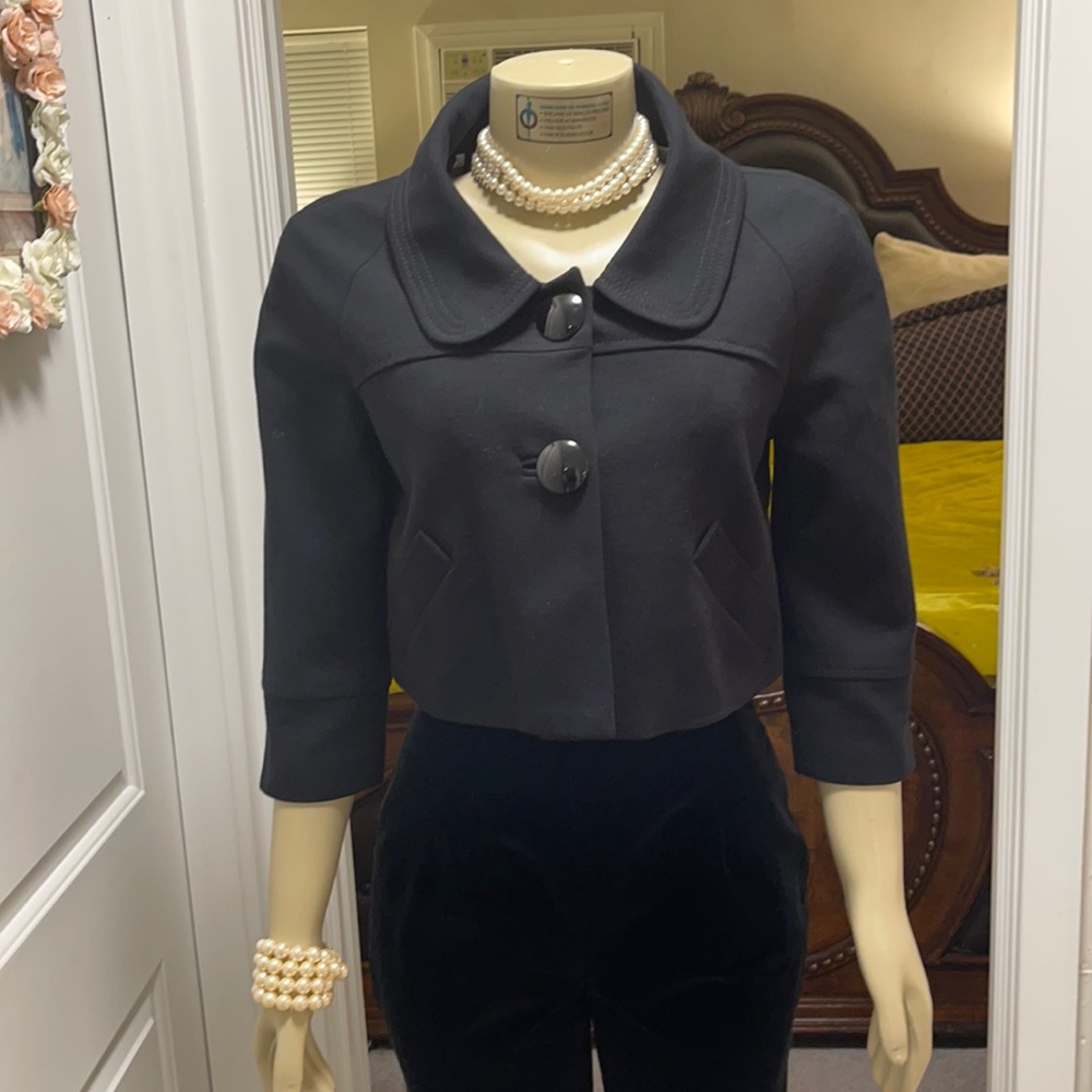 Black traditional big button style jacket.